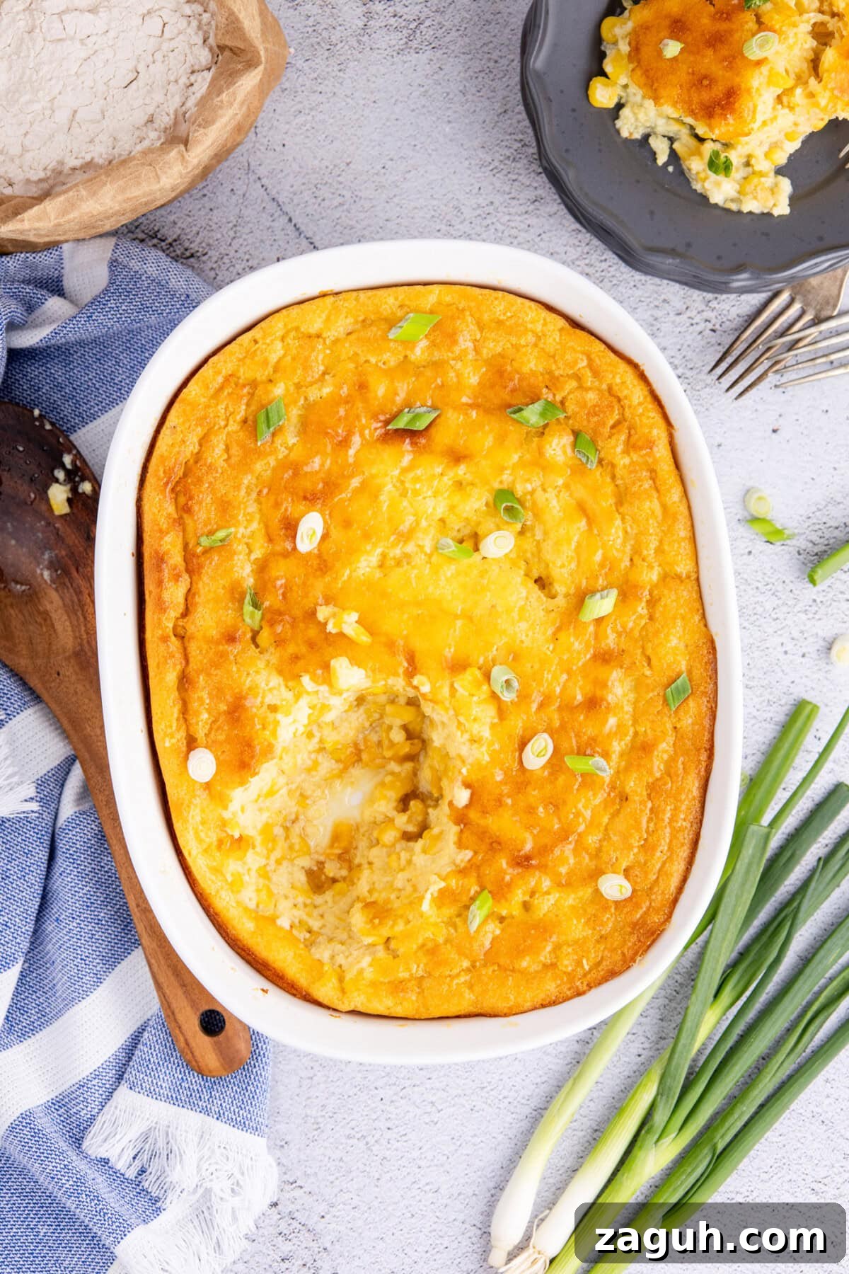 Creamy Southern-Style Corn Pudding Recipe 2 Corn Pudding in a baking dish with a serving removed