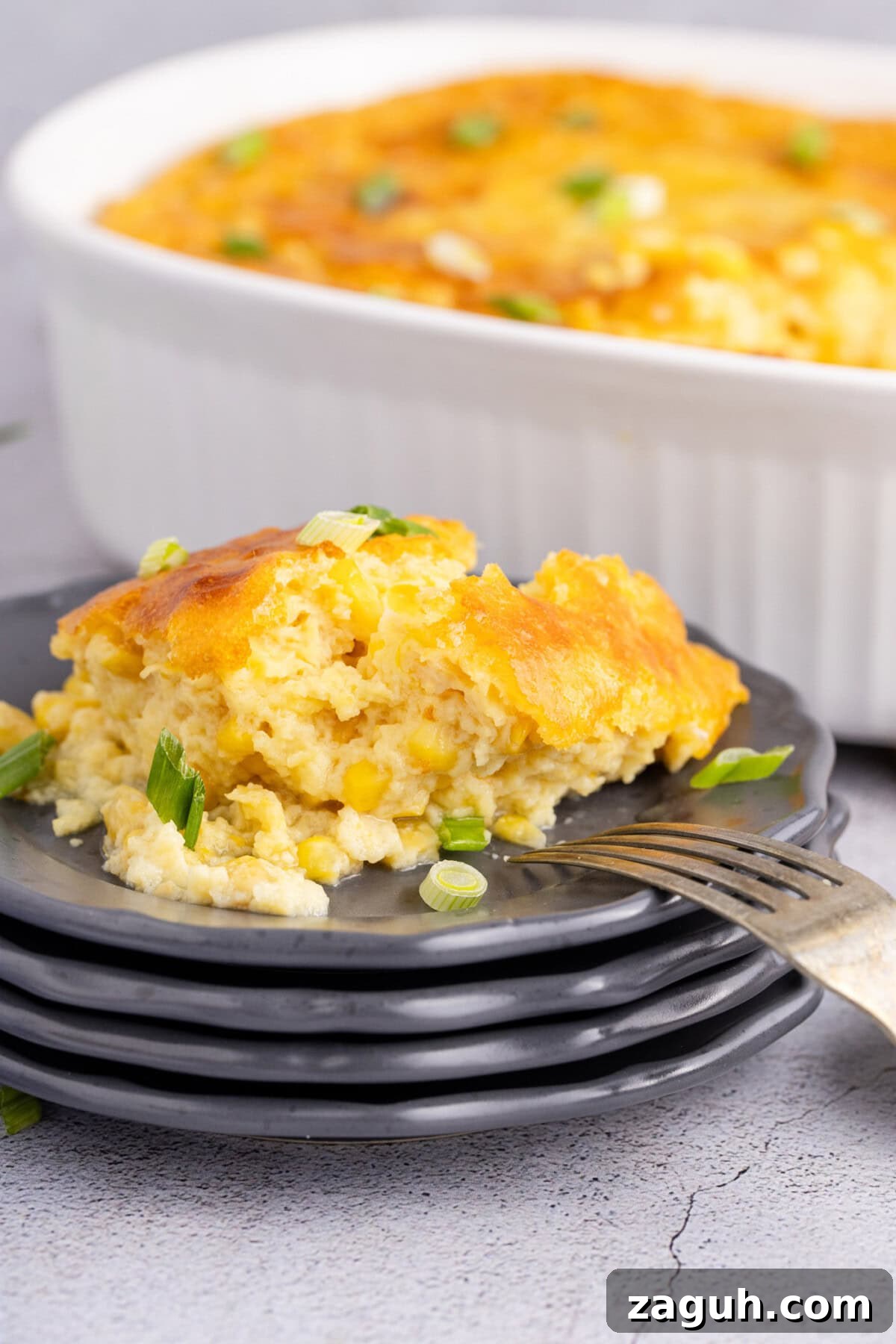 Creamy Southern-Style Corn Pudding Recipe 11 Corn Pudding on a plate with a fork