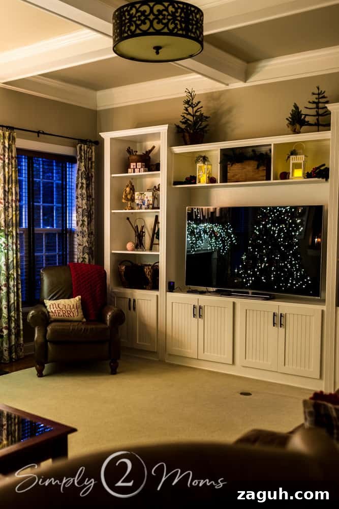 Classic Christmas Candlelight Tour You Have to See This Year 15 view of built in bookshelves decorated for Christmas at night