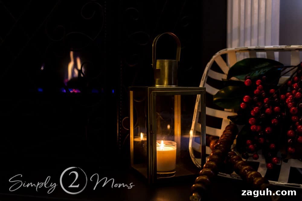 Classic Christmas Candlelight Tour You Have to See This Year 8 hearth side view of lantern with candle burning inside, tobacco basket, vintage spindles, red berries and magnolia leaves