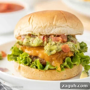 Savory cheeseburger with guacamole and lettuce.