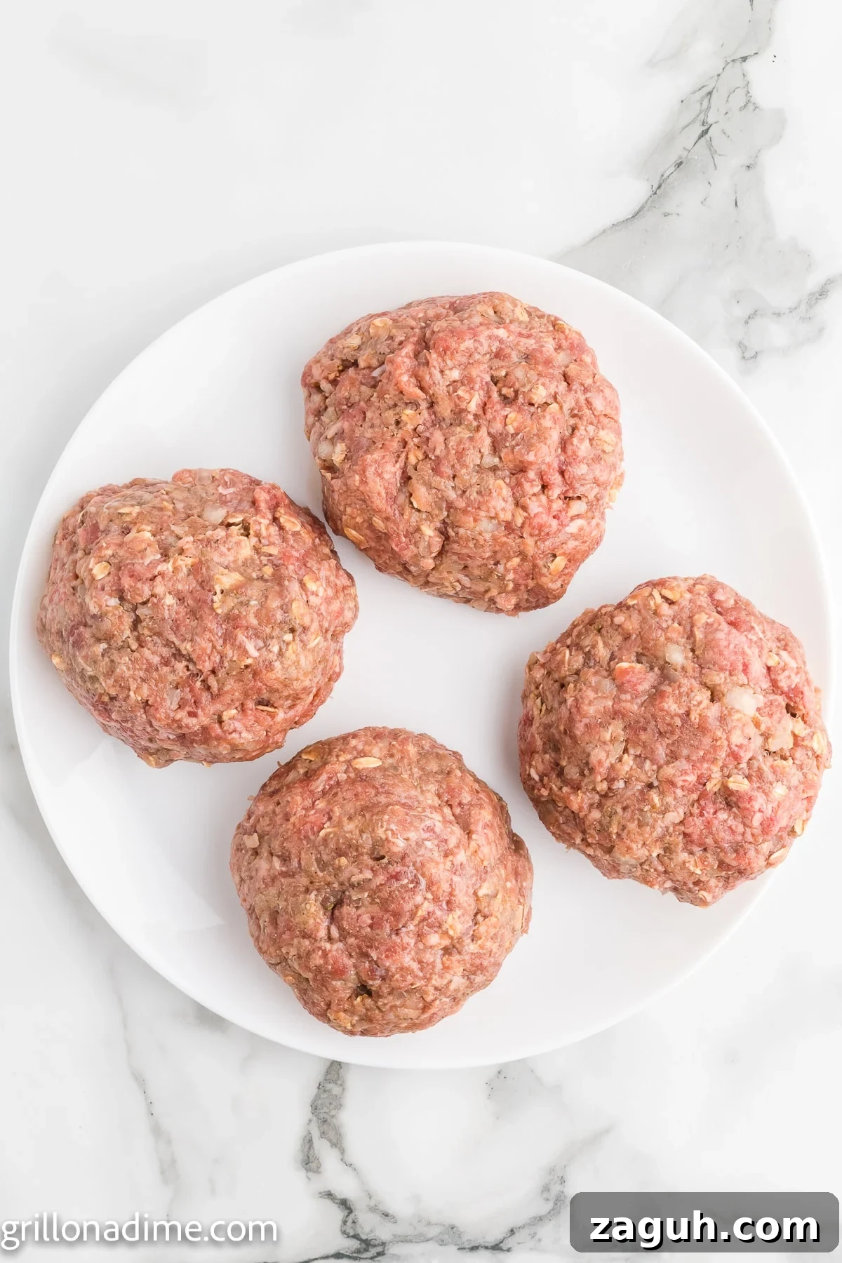 Ground beef patties on a white plate