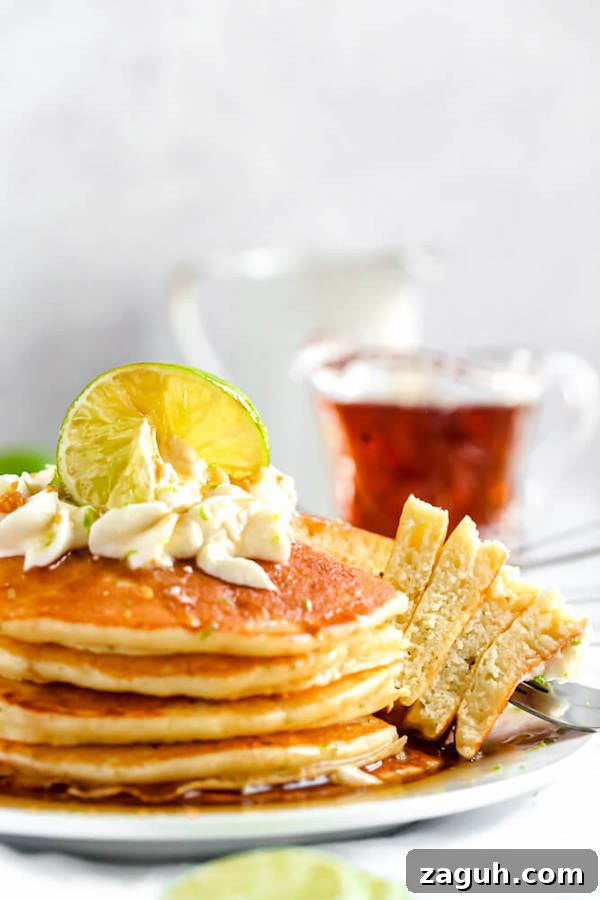Serve Key Lime Pie Pancakes with whipped cream and graham crumbs lime pancakes with whipped cream, graham cracker crumbs, lime zest and a lime twist on top