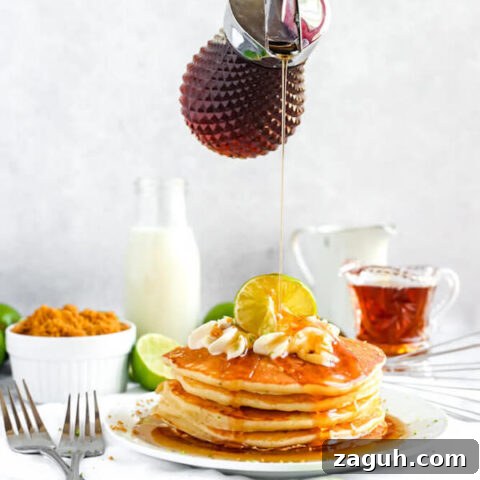 lime pancakes with whipped cream, graham cracker crumbs, lime zest and a lime twist on top