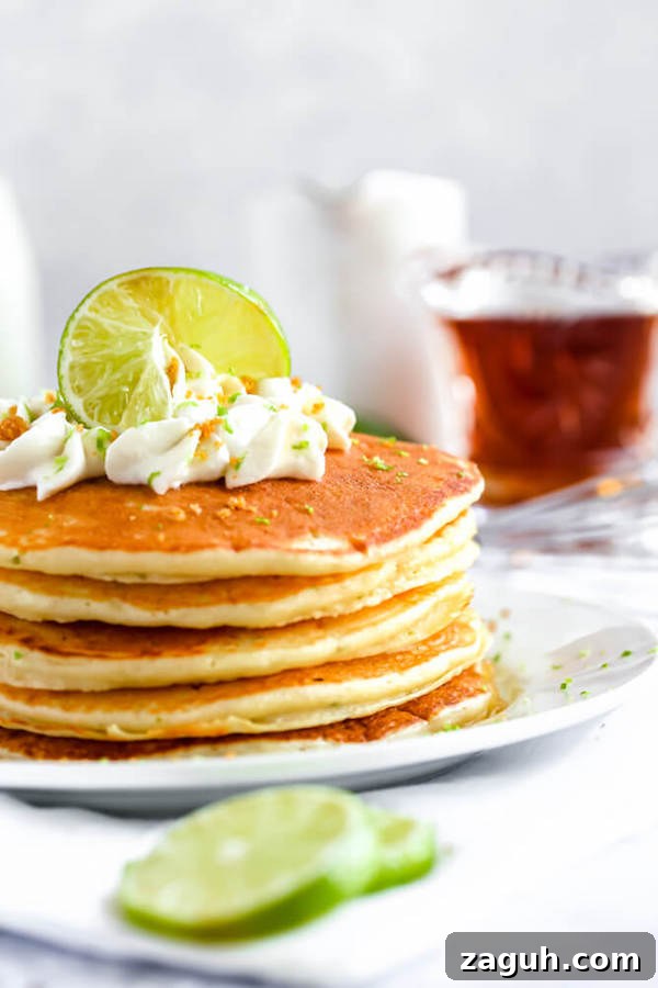 Key Lime Pancakes topped with whipped cream and graham cracker crumbs lime pancakes with whipped cream, graham cracker crumbs, lime zest and a lime twist on top