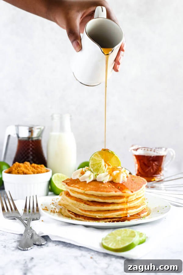 Key Lime Pie Pancakes with lime garnish lime pancakes with whipped cream, graham cracker crumbs, lime zest and a lime twist on top