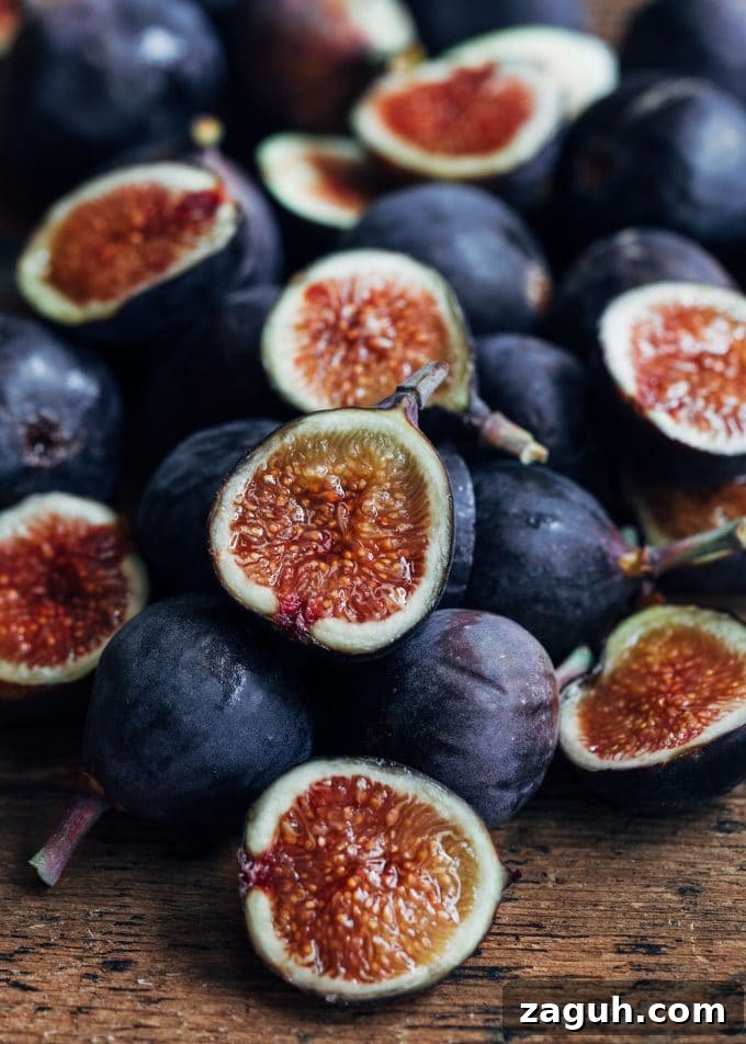 Fig Salad with Goat Cheese & Baby Arugula — Spring Entertaining Recipe 3 whole and halved figs on a wood board