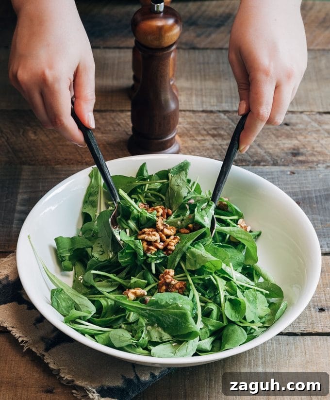 Fig Salad with Goat Cheese & Baby Arugula — Spring Entertaining Recipe 4 tossing baby arugula and walnuts with vinaigrette