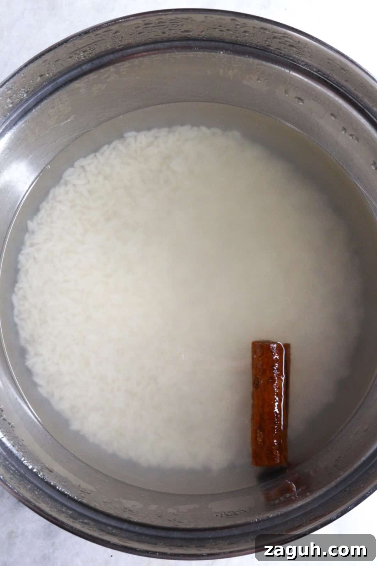Refreshing Horchata Agua Fresca Recipe: Traditional Mexican Rice Drink 4 Bowl with white rice and cinnamon stick covered with water