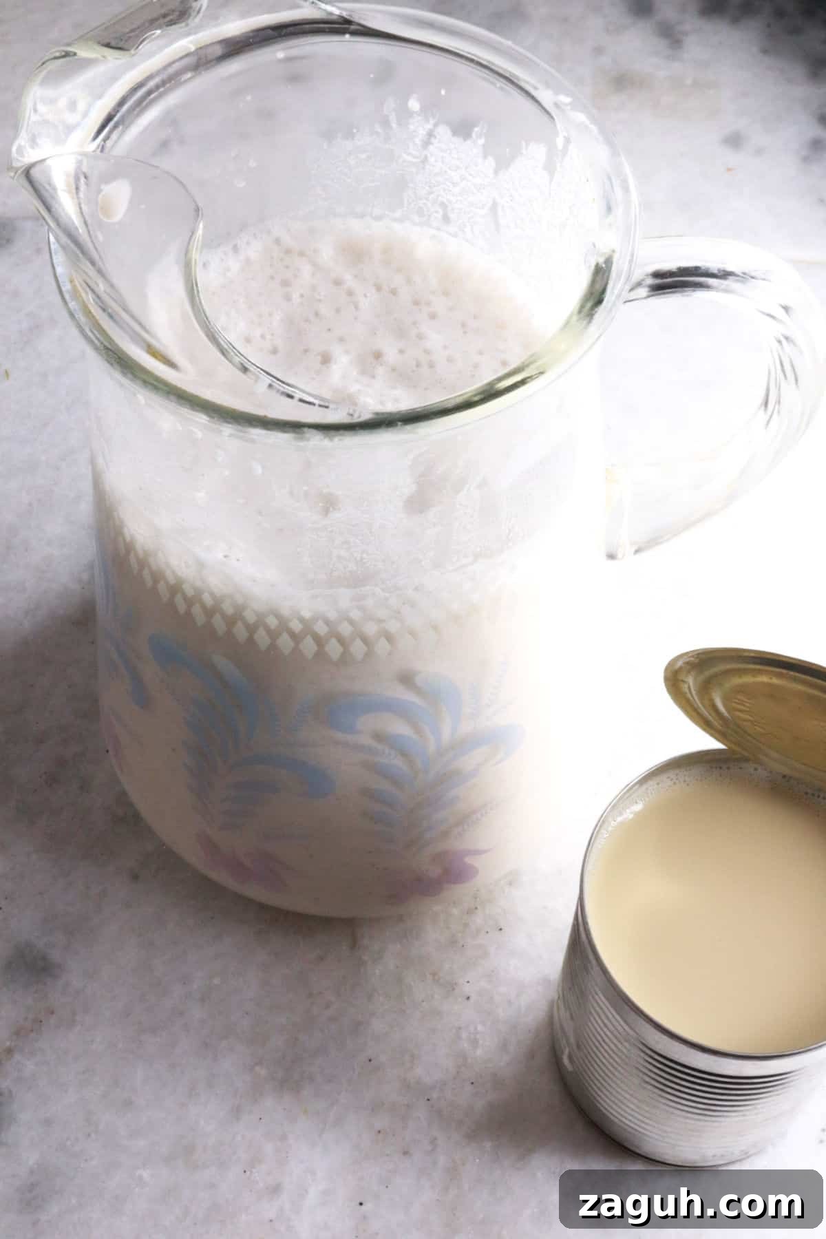 Refreshing Horchata Agua Fresca Recipe: Traditional Mexican Rice Drink 8 Horchata in a glass pitcher and a can of evaporated milk beside it.