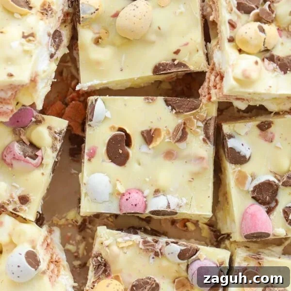 Decadent Chocolate Easter Cupcakes with Spring Decorations 12 A slab of Easter Mini Egg Rocky Road made with white chocolate, cut into bitesized squares.