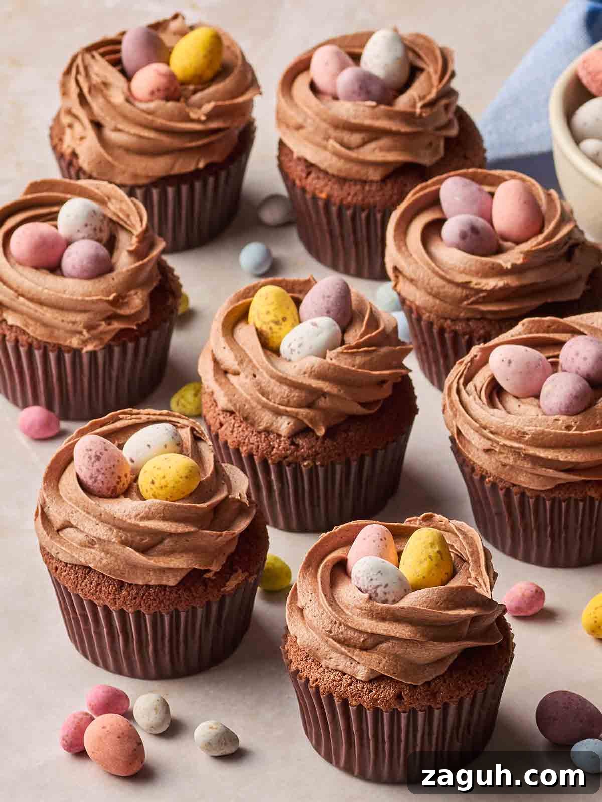 Decadent Chocolate Easter Cupcakes with Spring Decorations 3 A batch of Chocolate Easter Cupcakes with mini eggs on top on a white surface.