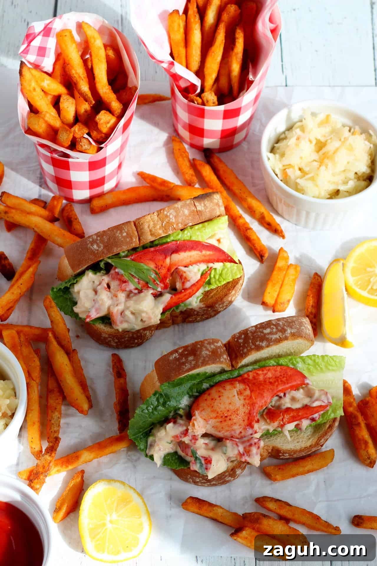 Classic New England Lobster Rolls: Authentic Recipe & Tips 2 two lobster rolls in hot dog buns with sweet potato fries laying around