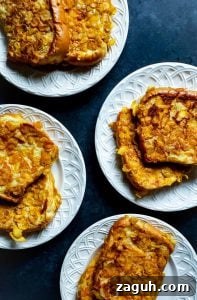 Crispy Buttermilk French Toast Four white plates on a blue counter with french toast on them.