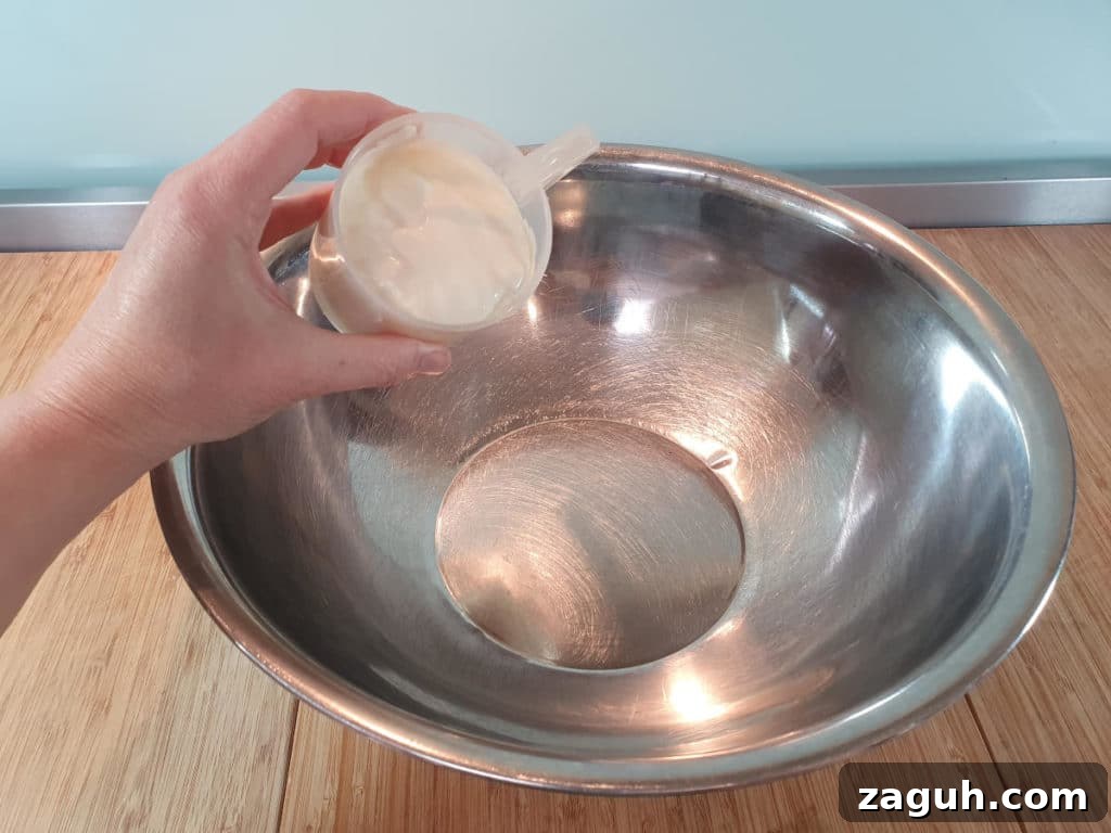 Peanut Butter & Jelly Ice Cream Recipe: Creamy PB&J Frozen Treat 4 Adding cream to bowl