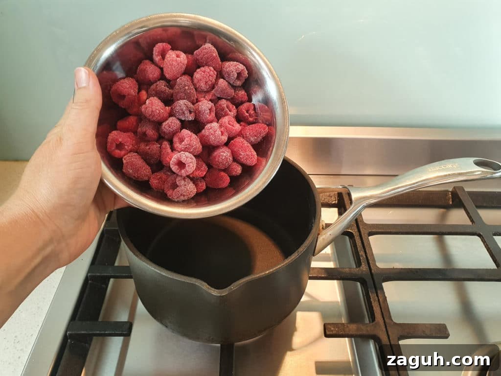 Peanut Butter & Jelly Ice Cream Recipe: Creamy PB&J Frozen Treat 8 Adding raspberries to pot