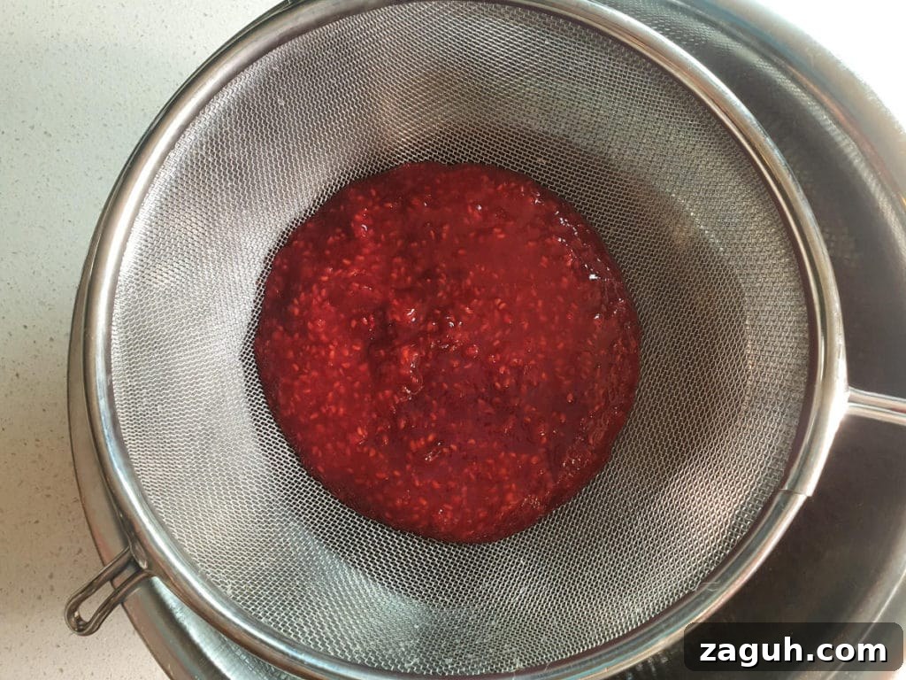 Peanut Butter & Jelly Ice Cream Recipe: Creamy PB&J Frozen Treat 10 Straining raspberry mix