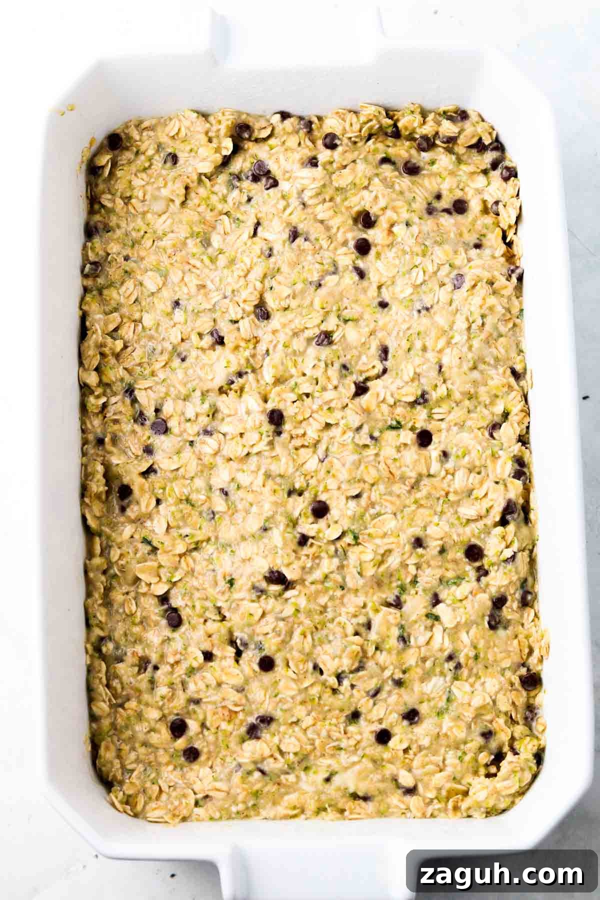 Moist Zucchini Oatmeal Bars with Cinnamon and Walnuts 3 Oatmeal bars placed in a casserole dish.