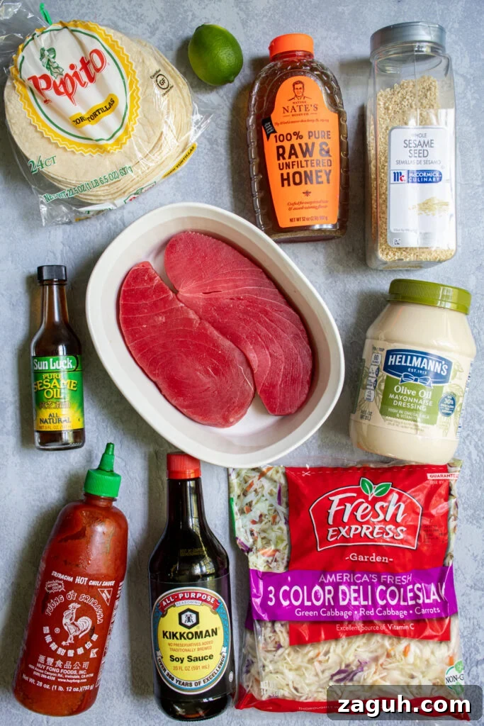 Grilled Tuna Steak Tacos with Crunchy Coleslaw 4 Ingredients needed to make tuna steak tacos laid out on a tabletop.
