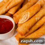 Filipino Lumpia: Classic Crispy Spring Rolls Recipe 22 Close up of lumpia cut in half thumbnail shot.