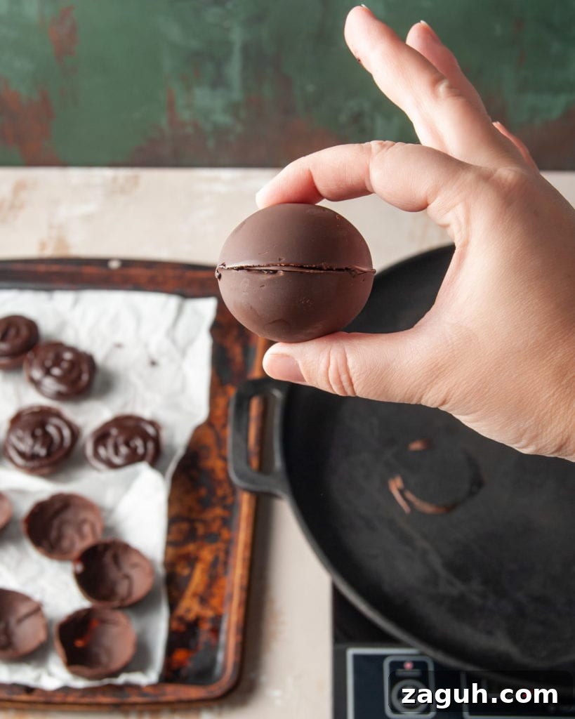 Baileys Hot Chocolate Bombs Recipe: Homemade Boozy Cocoa Surprises 13 Sealing two chocolate half spheres to form a hot chocolate bomb.