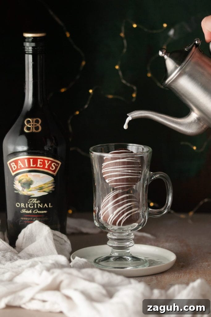 Baileys Hot Chocolate Bombs Recipe: Homemade Boozy Cocoa Surprises 14 Pouring Hot Milk Over Bailey's Hot Chocolate 1