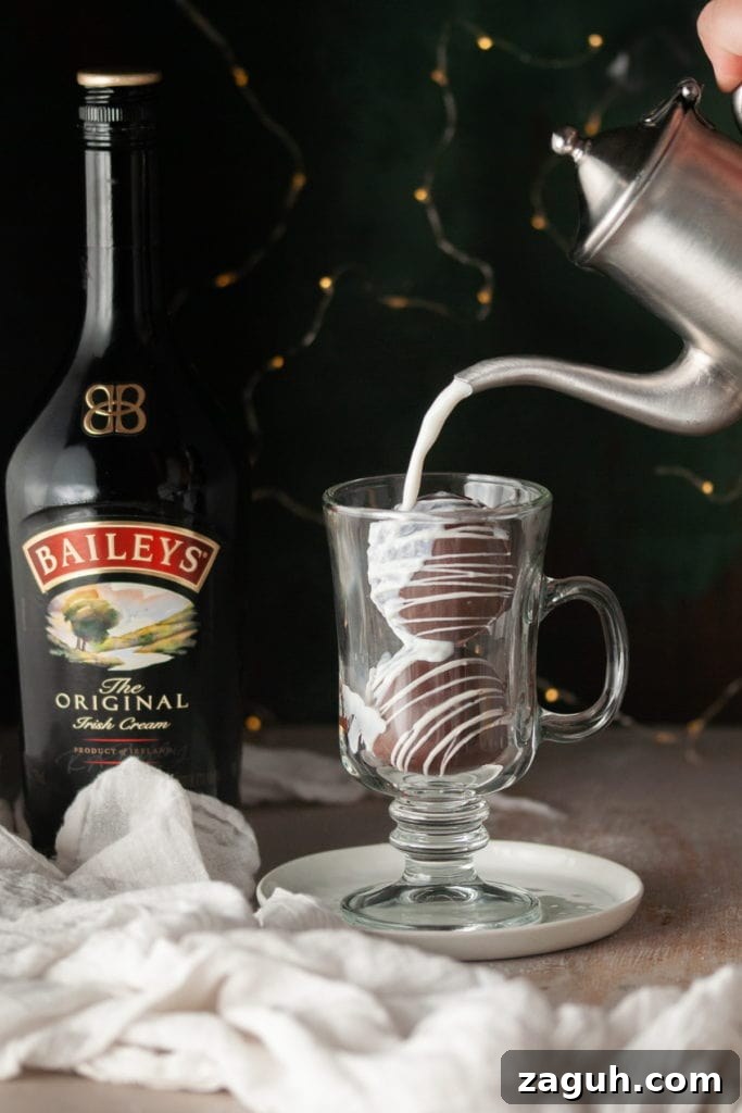 Baileys Hot Chocolate Bombs Recipe: Homemade Boozy Cocoa Surprises 15 Pouring hot milk over Bailey's hot chocolate bombs.