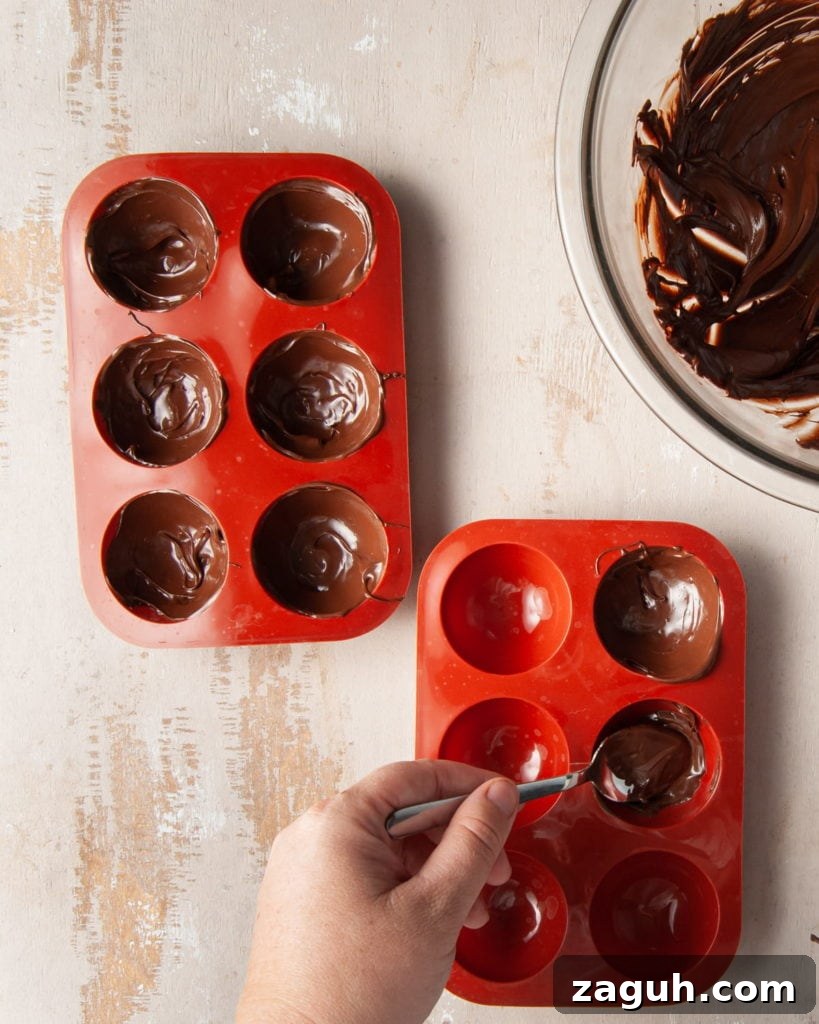 Baileys Hot Chocolate Bombs Recipe: Homemade Boozy Cocoa Surprises 5 filling spherical chocolate molds with tempered chocolate