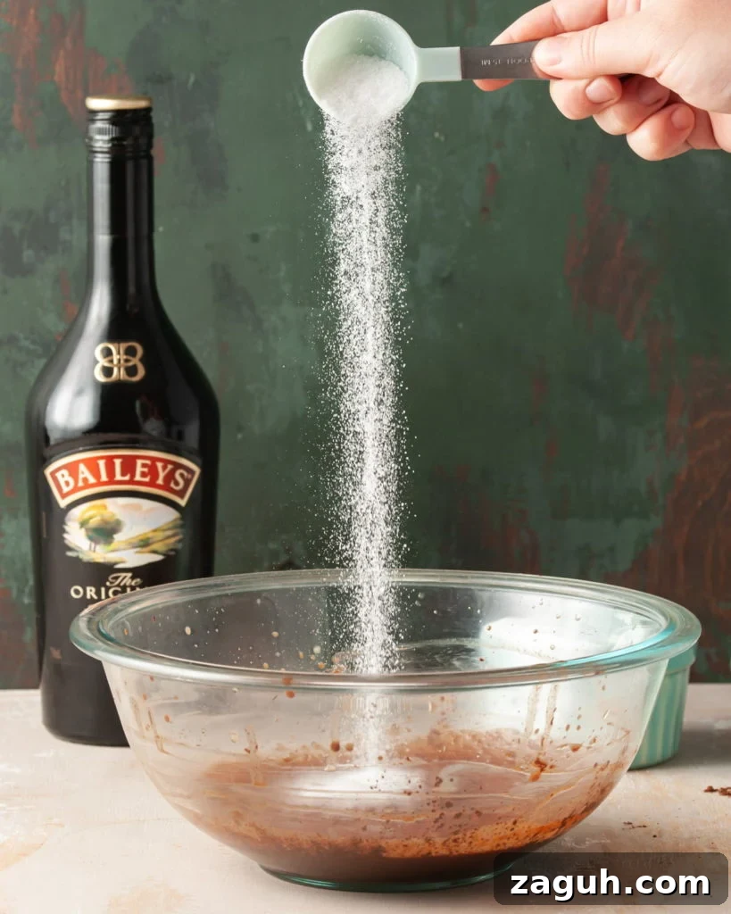Baileys Hot Chocolate Bombs Recipe: Homemade Boozy Cocoa Surprises 8 Adding sugar to large mixing bowl with hot chocolate mixture.