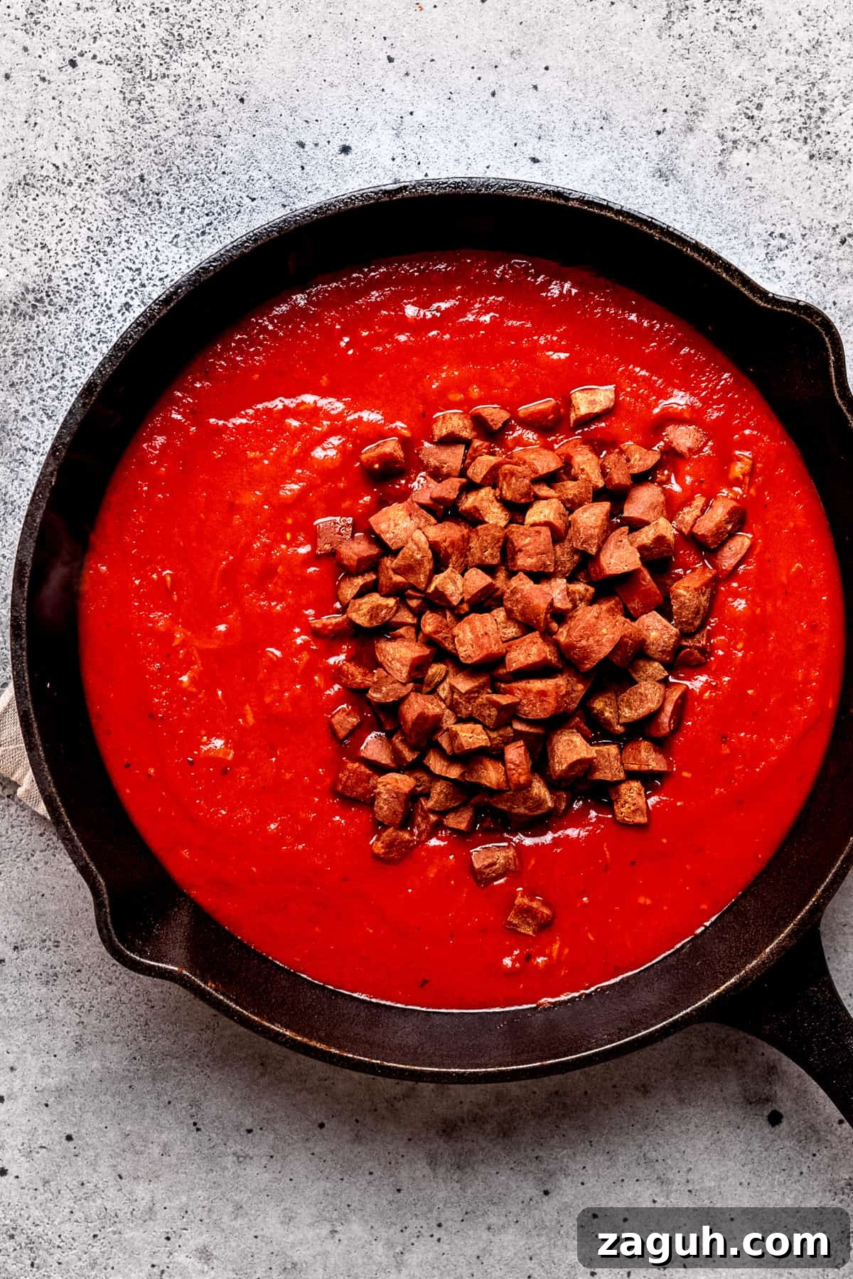 One-Pot Chorizo Pasta with 7 Ingredients — Ready Fast 8 Tomato sauce with chorizo being added.