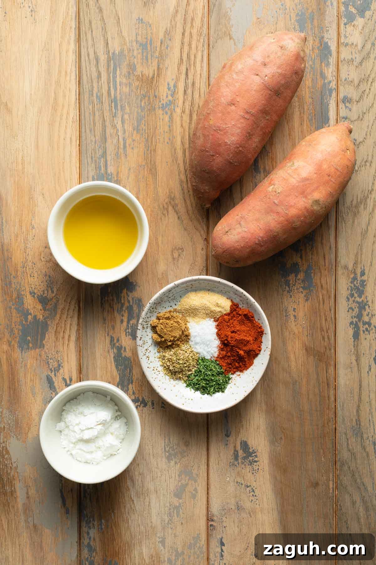 Crispy Air Fryer Sweet Potato Wedges Recipe 3 Ingredients to make air fryer sweet potato wedges arranged individually on a wooden surface.
