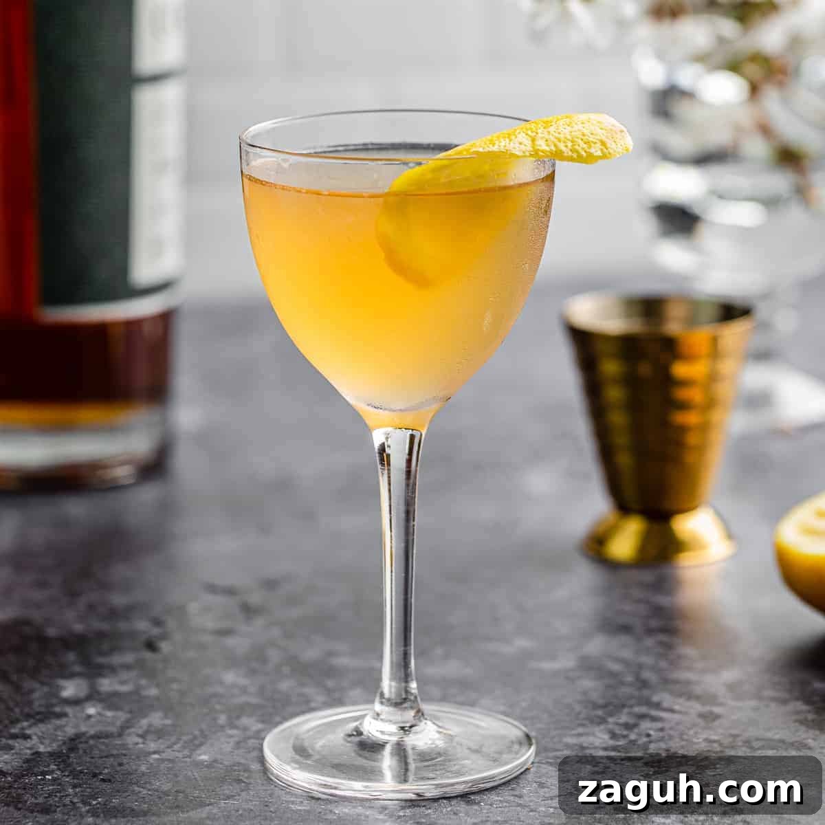 An earl grey gin cocktail on a grey table.