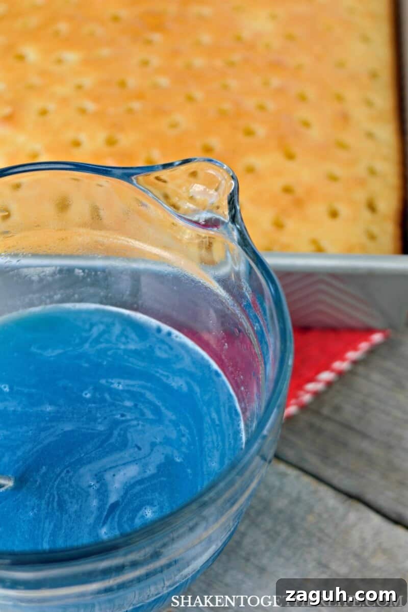 Blue Jell-o gives our Red, White & Blue Poke Cake one of its vibrant patriotic colors!