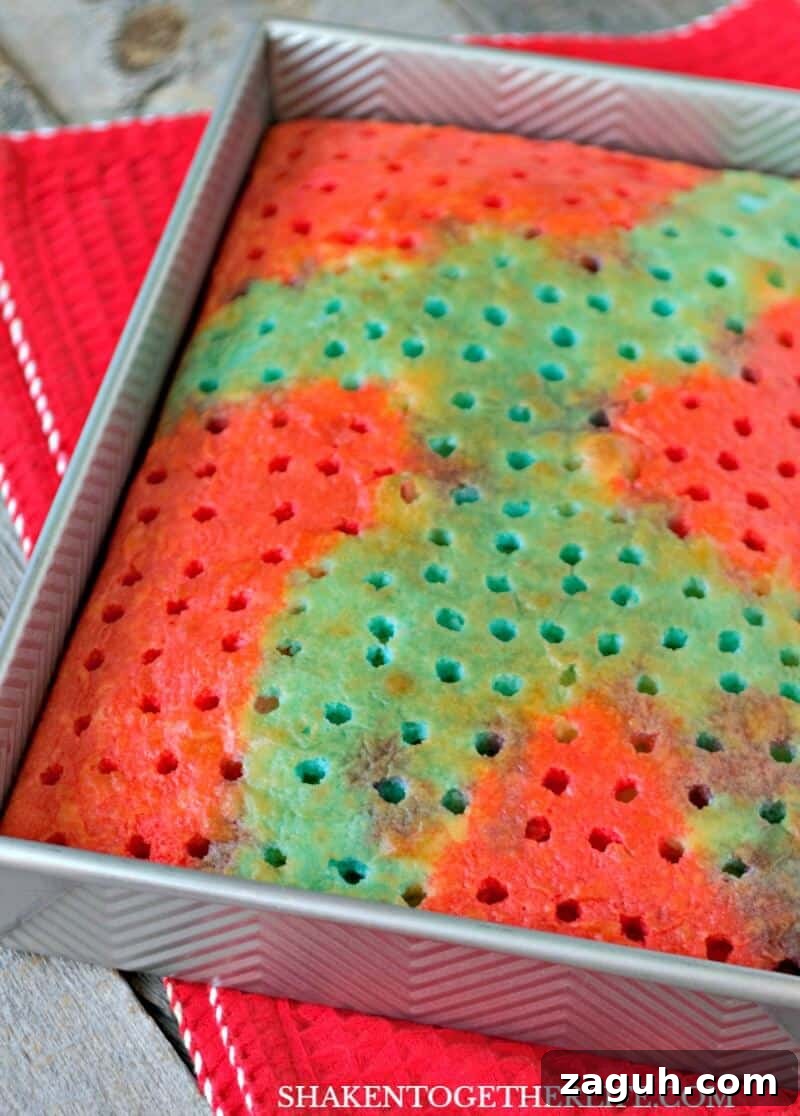 Carefully spoon red Jell-o over a portion of the cake for our Red, White & Blue Poke Cake