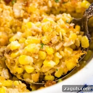 Creamy Corn Pudding Casserole Recipe for Comforting Sides 14 A close up image of a serving spoon holding a scoop of corn pudding in the pan of it.