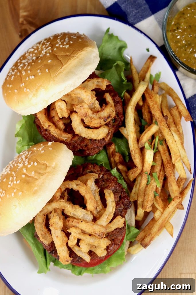 Platter of 2 Grilled Burgers with onion strings and fries