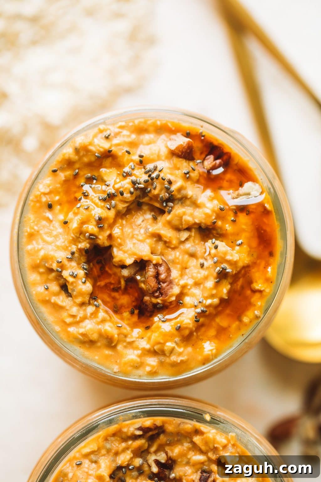 Creamy Pumpkin Overnight Oats Recipe for Fall Breakfast 3 easy pumpkin pie overnight oats in glass jar topped with maple syrup and pecans