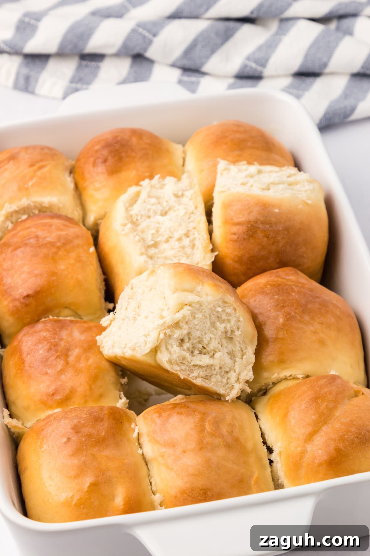 This recipe for Sourdough Rolls results in the softest and fluffiest dinner rolls you will ever have. sourdough rolls baked in baking dish