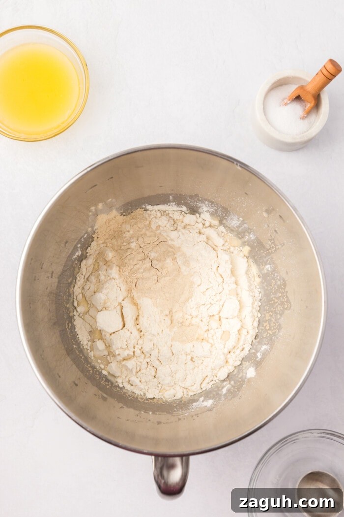 Mixing dough sourdough rolls in mixing bowl