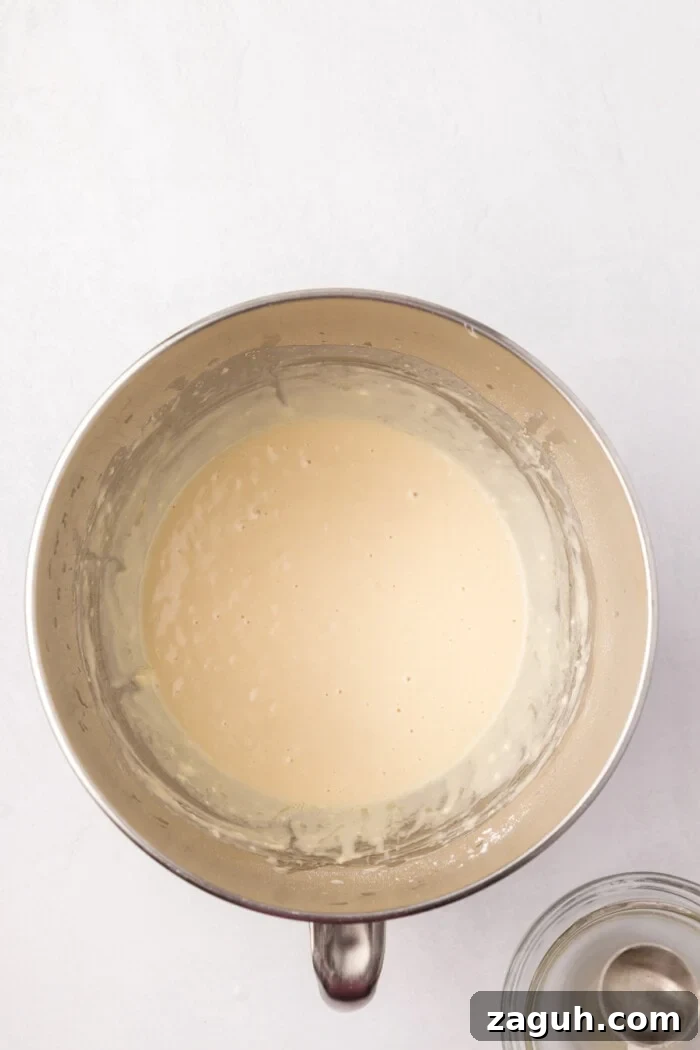 Dough beginning to form sourdough starter in mixing bowl