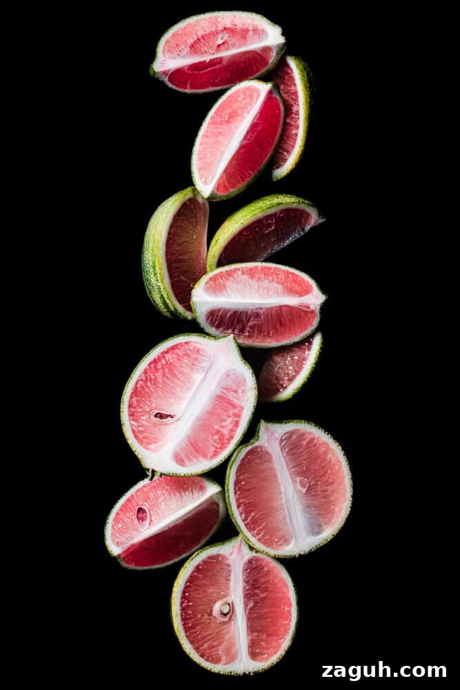Pink Lemons Explained: What They Are, How They Taste, and Uses 2 Pink lemon slices on a black background