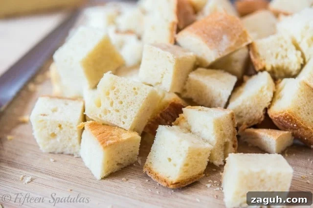Sausage Breakfast Casserole Cubes of Bread on Cutting Board