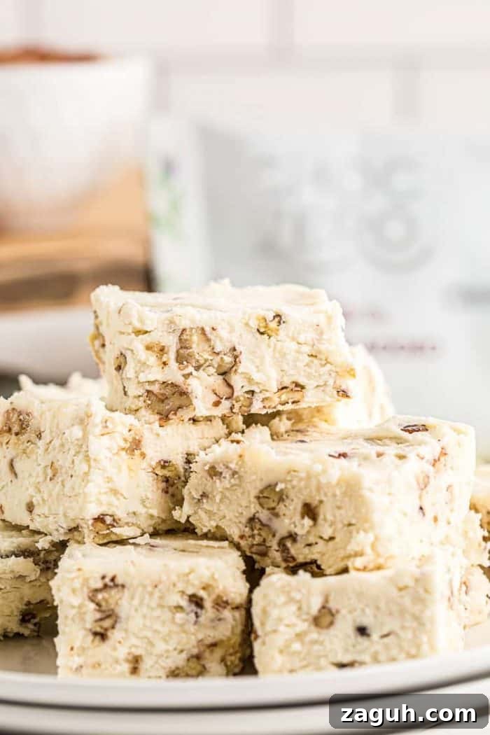 Keto White Chocolate Pecan Fudge — 2g Net Carbs Per Serving 2 keto white chocolate fudge cut and stacked on a plate