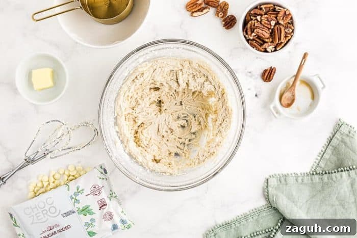 Keto White Chocolate Pecan Fudge — 2g Net Carbs Per Serving 4 overhead view of whipped cream cheese and butter by pecans for sugar free fudge recipe