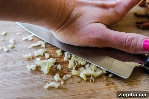 Make-Ahead Garlic Green Beans with Almonds and Crispy Breadcrumbs 8 crushing garlic with a knife.