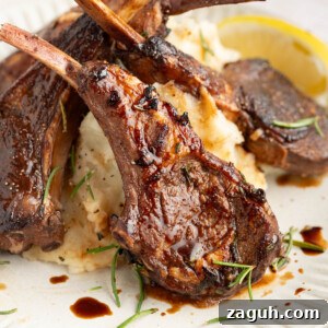 Balsamic-Glazed Oven-Baked Lamb Chops for Weeknight Dinner 11 Three baked lamb chops on a plate with mashed potatoes.
