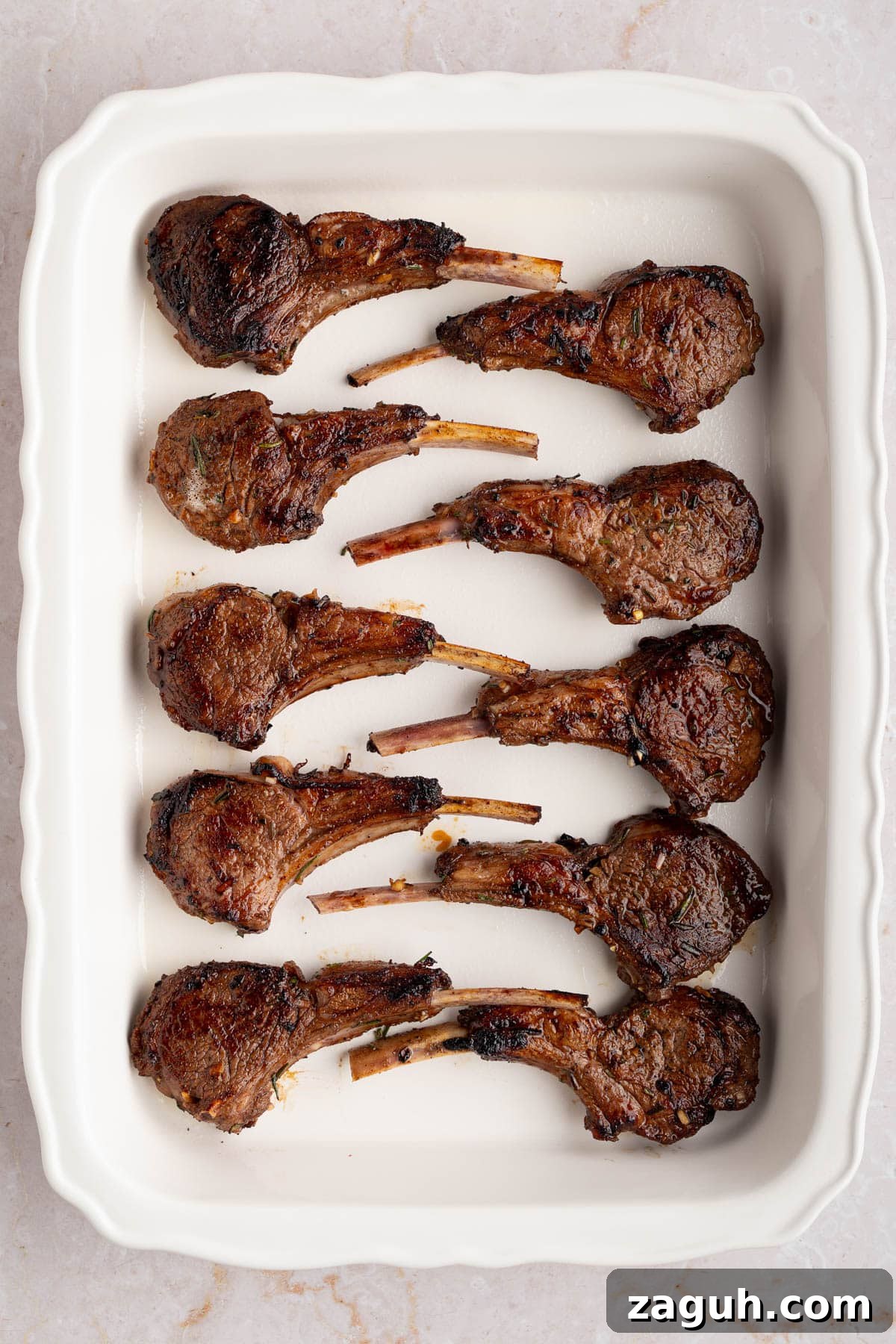 Balsamic-Glazed Oven-Baked Lamb Chops for Weeknight Dinner 6 The seared lamb chops in a white baking dish before baking.