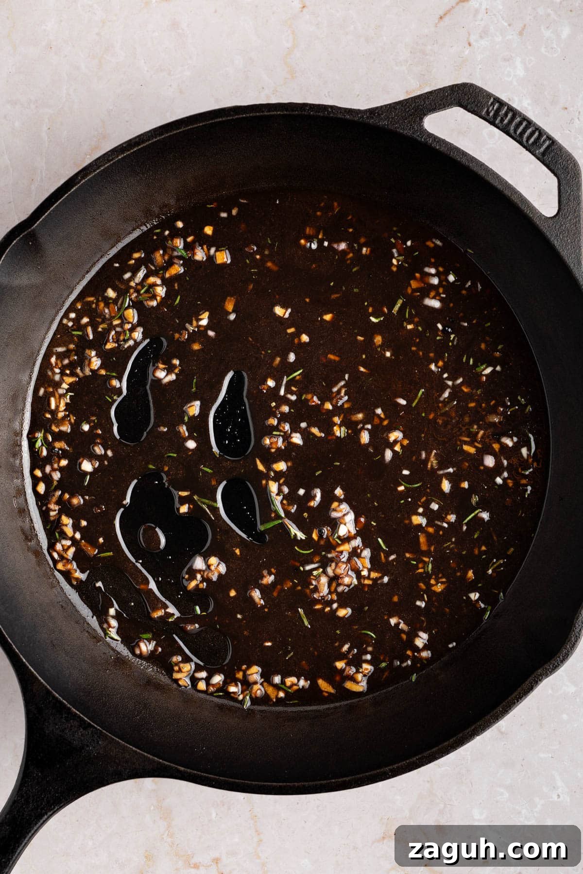 Balsamic-Glazed Oven-Baked Lamb Chops for Weeknight Dinner 7 The glaze cooking down in the skillet.