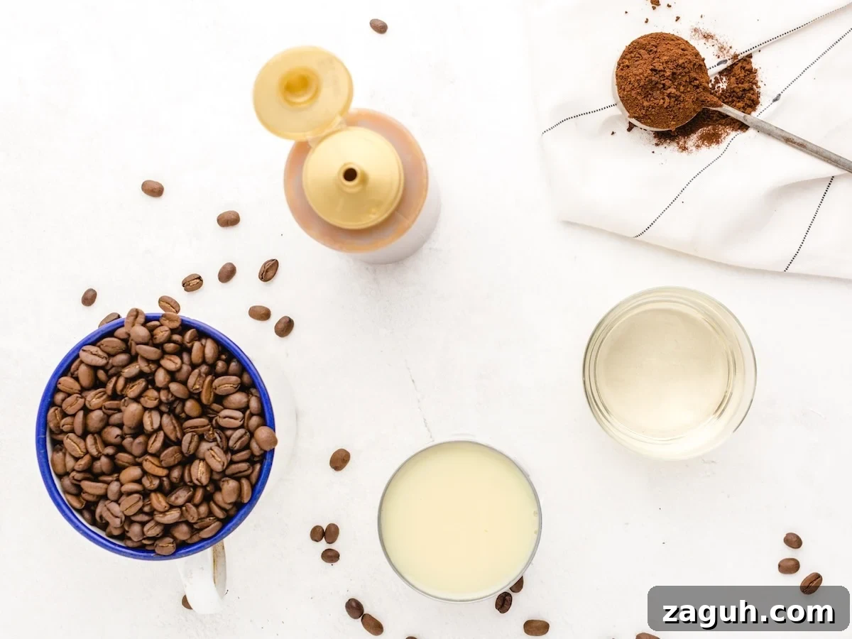 A mug filled with coffee beans, a glass of condensed milk, a jar of clear liquid, and ingredients for an Iced Caramel Macchiato Recipe are artfully arranged on a white surface, ready to make the perfect Iced Caramel Macchiato.