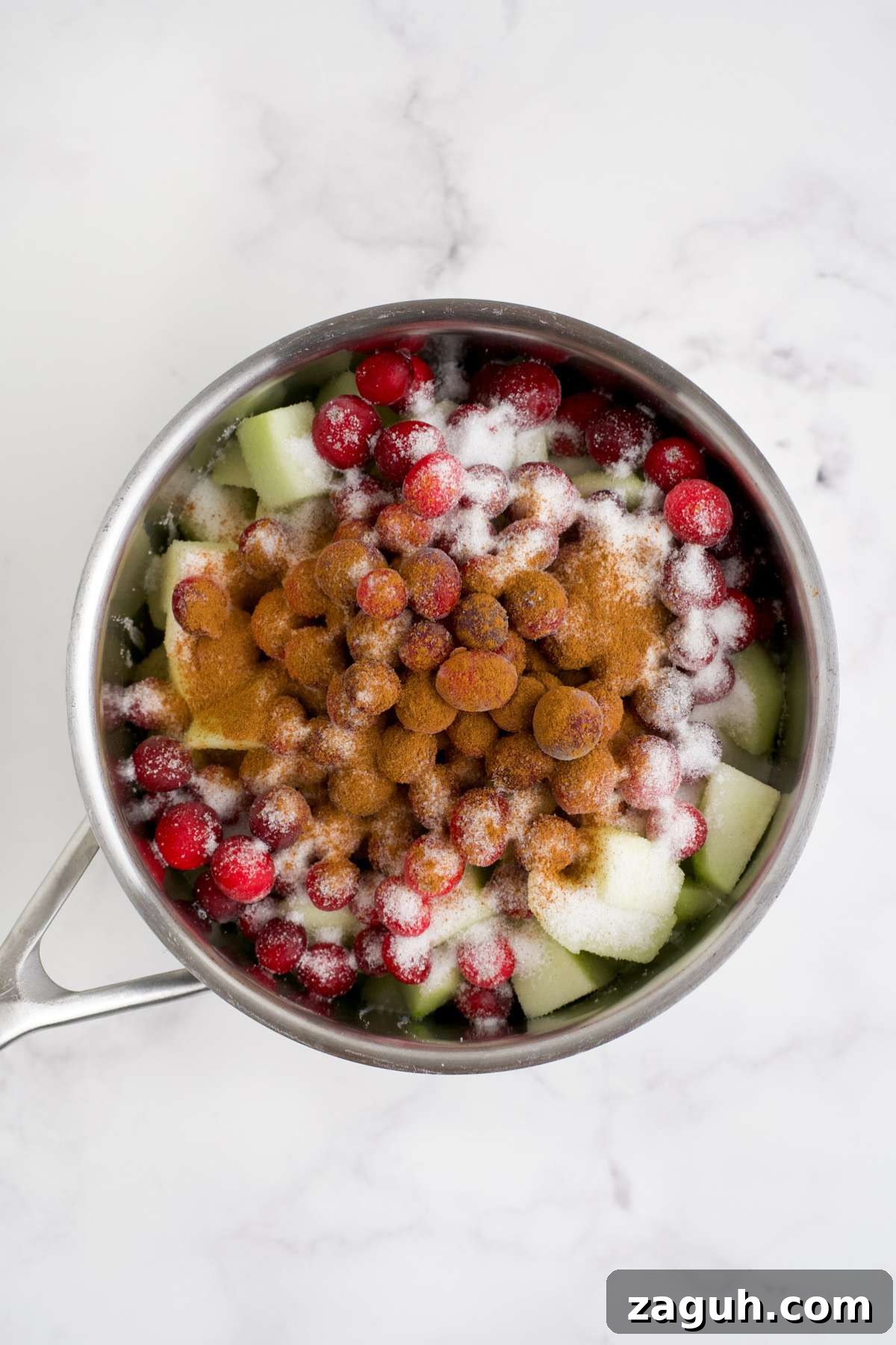 Cranberry Apple Sauce Recipe: Tangy Homemade Spread for Fall 5 Ingredients to make cranberry applesauce in a pot.
